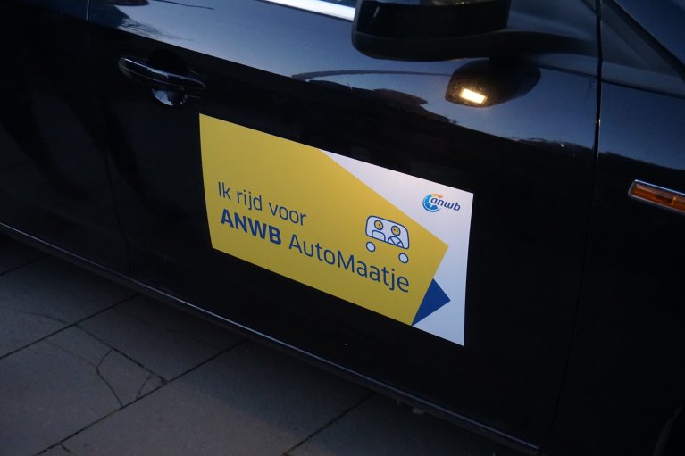 Auto met sticker erop met 'Ik rijd voor ANWB AutoMaatje'