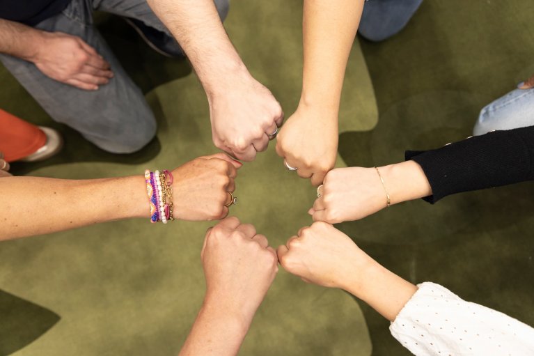 6 handen komen samen in een boks