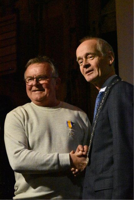 Burgemeester Niek Meijer schudt de hand van decorandus Martin Vlaanderen