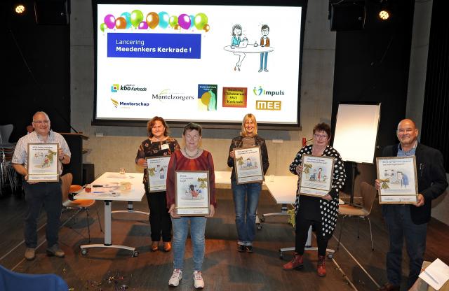 Wethouder Jongen en vertegenwoordigers van de meedenkersorganisaties poseren met een ingelijste poster in hun handen