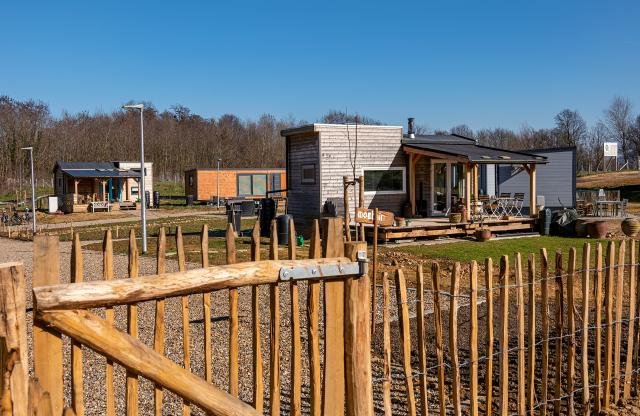 The Tiny Houses Carisborg seen from behind a wooden fence