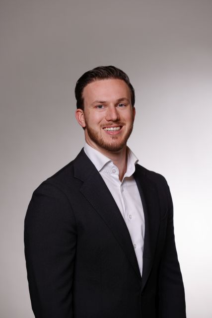 Persoon in een licht overhemd en donker jasje