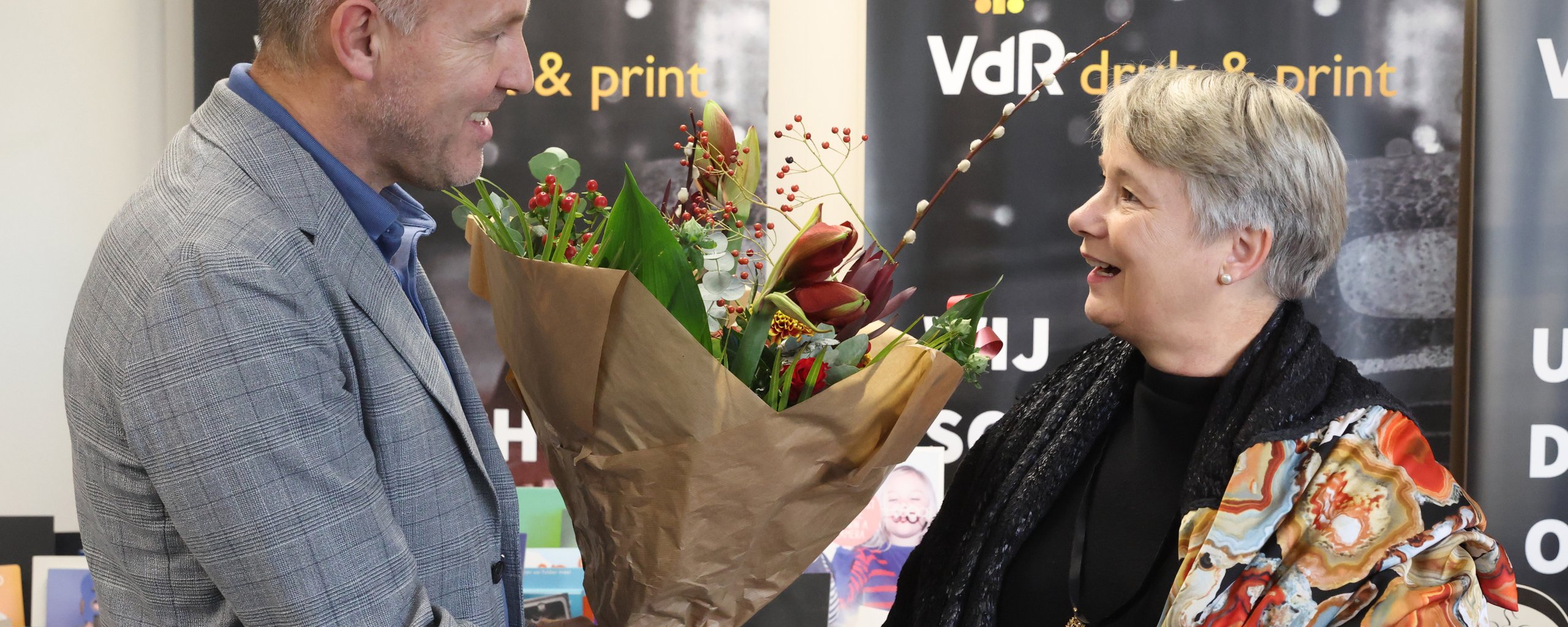Wethouder Broekman reikt bloemen uit aan Bertil van de Ridder