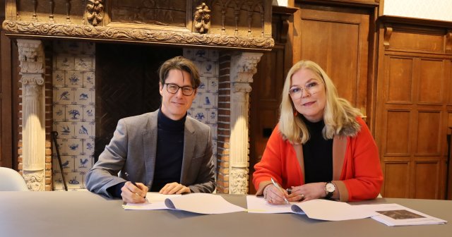 Bestuurder Joeri Kapteijns van het COA en burgemeester Van Toorenburg schudden elkaar de hand na het ondertekenen van de bestuursovereenkomst