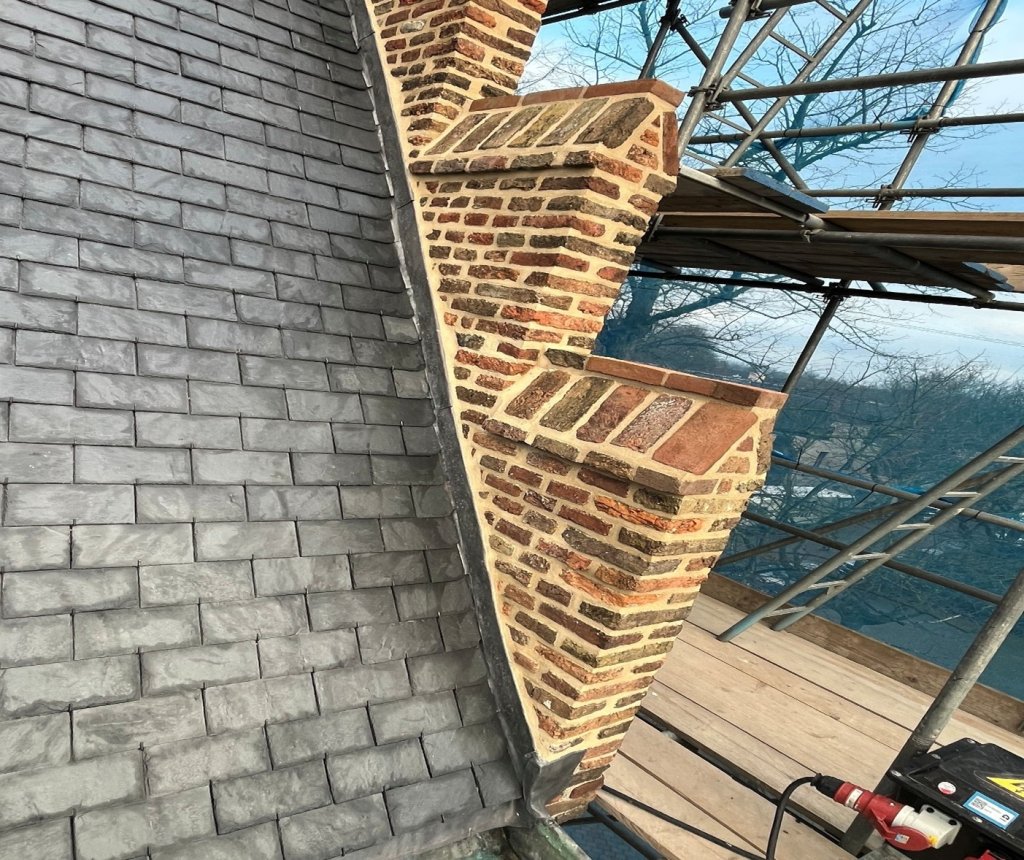 Restauratie van het steen- en voegwerk van de trapgevel en de ezelsruggen aan de rechter voorzijde.