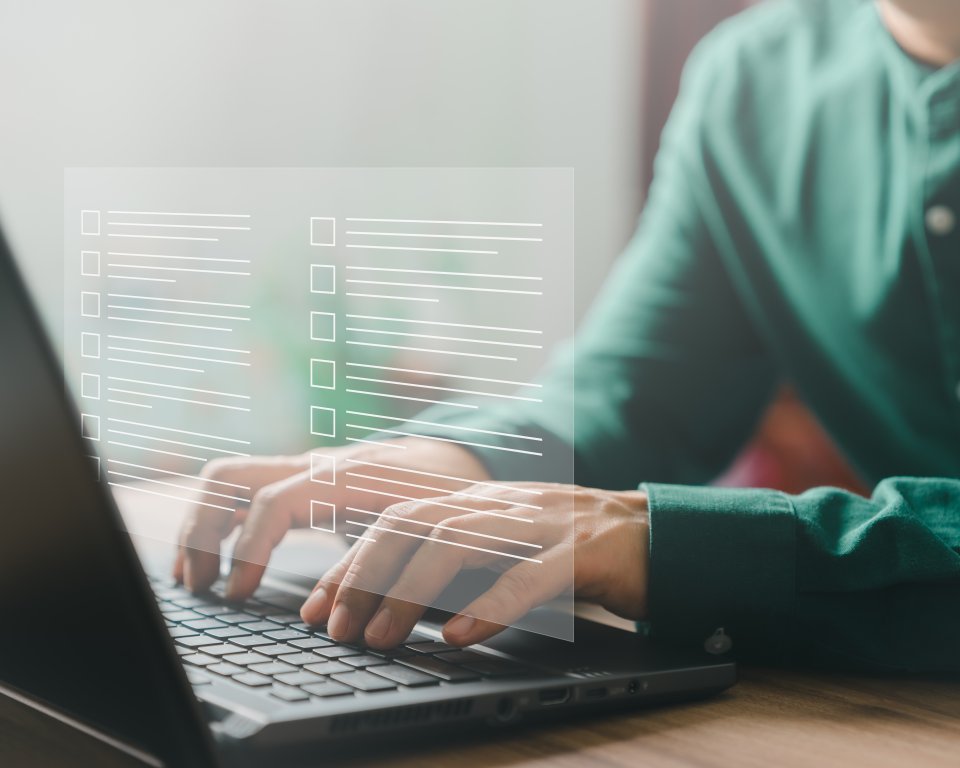Adult man using laptop computer with virtual screen contact questionnaire with checkbox