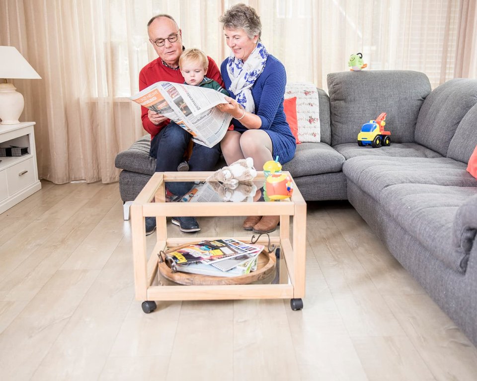 Opa en oma lezen krant met kleinkind