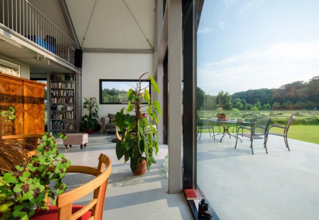 Woonkamer met doorkijkje naar buiten van het duurzame huis Martijn Bos