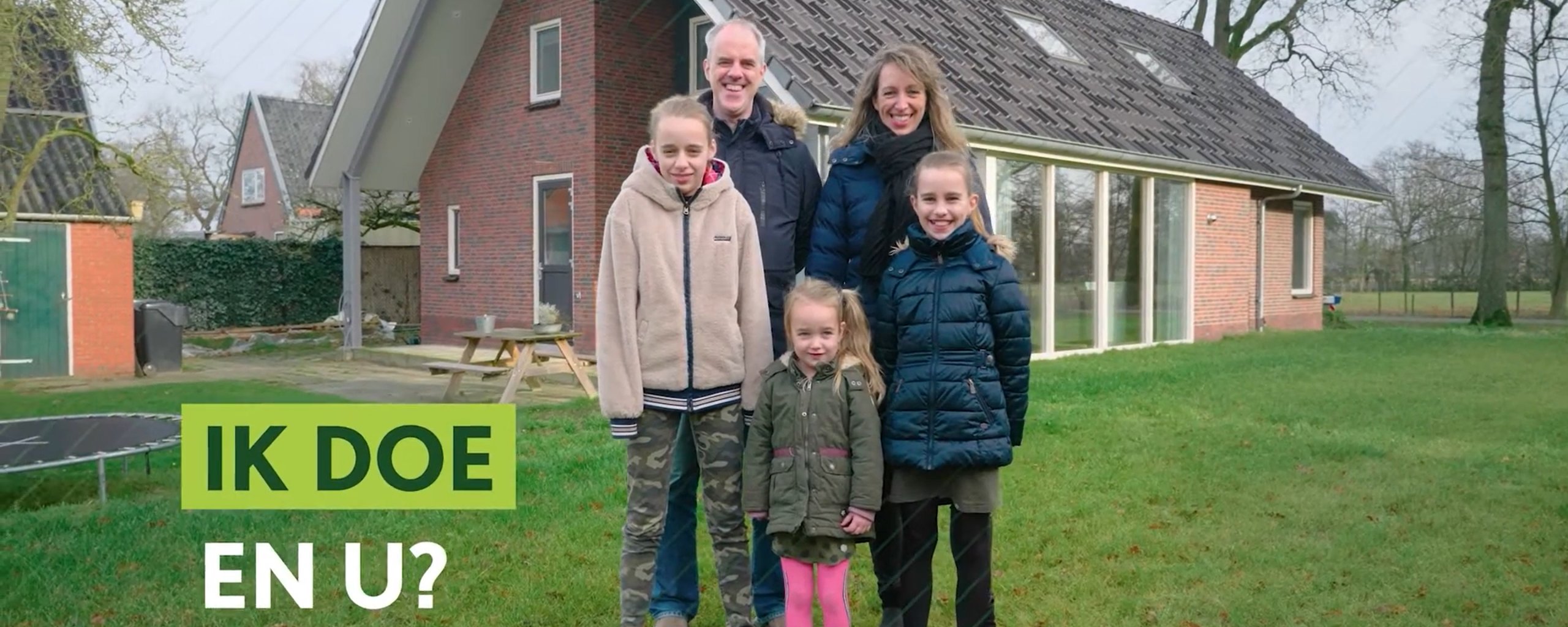 Hette Feenstra and his family standing in front of their preserved home