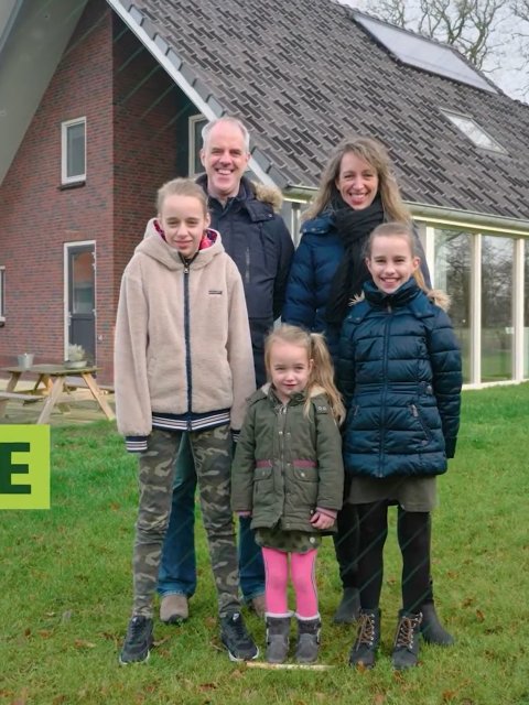 Hette Feenstra and his family standing in front of their preserved home