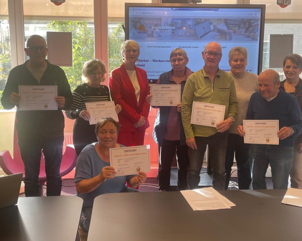 Groepsfoto van de acht deelnemers aan de cursus Digisterker samen met wethouder Hetty van der Hamsvoort