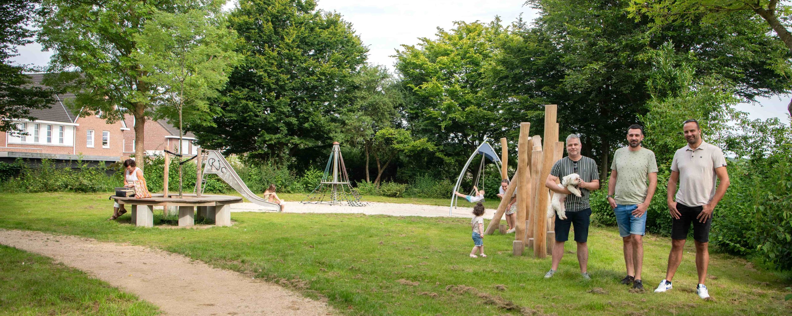 Paul, Marcel en Raymond met de kinderen op de speelweide