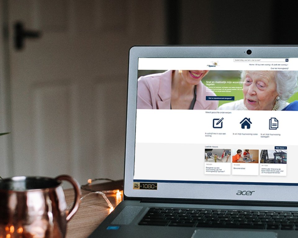 Photo of a laptop showing the home page of the website of housing company opmeer