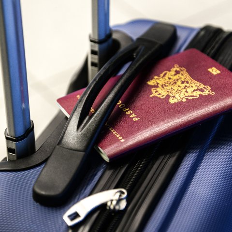 Passport on a blue suitcase