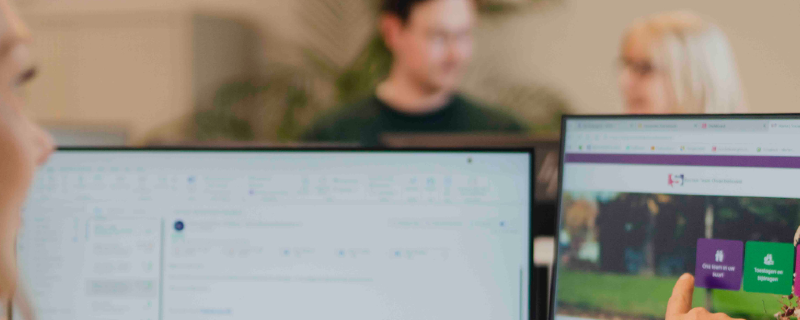 medewerker die vanachter haar bureau het computerscherm aanwijst