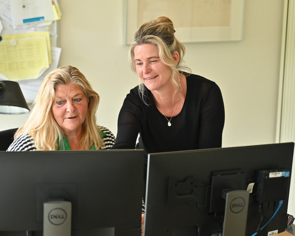 2 collega's kijken samen naar de schermen