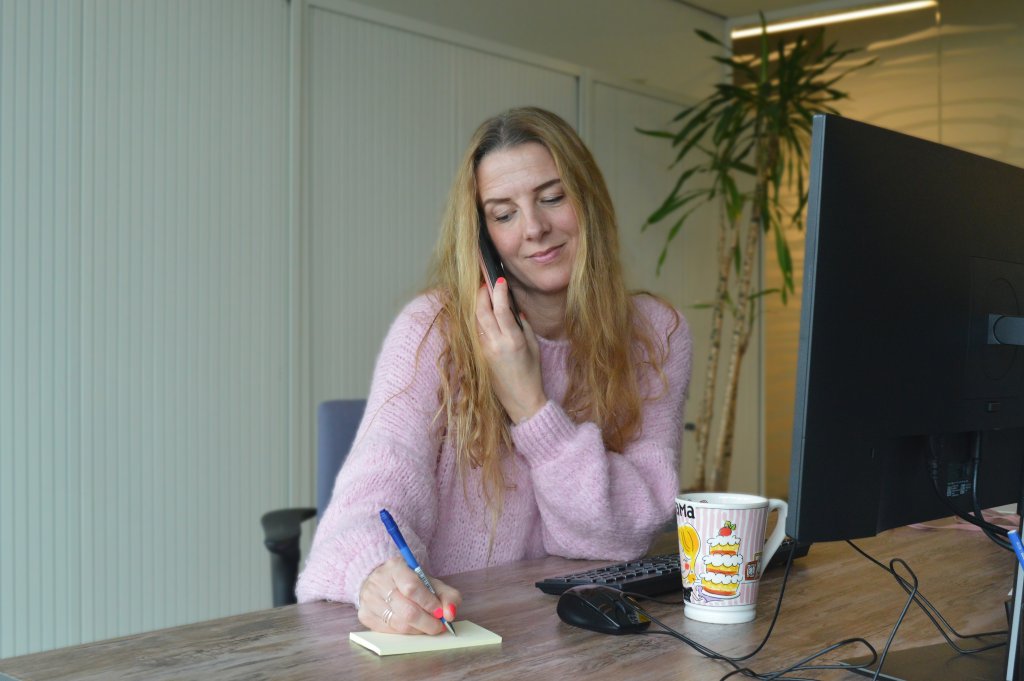 Nienke de Vries aan het bellen aan een bureau