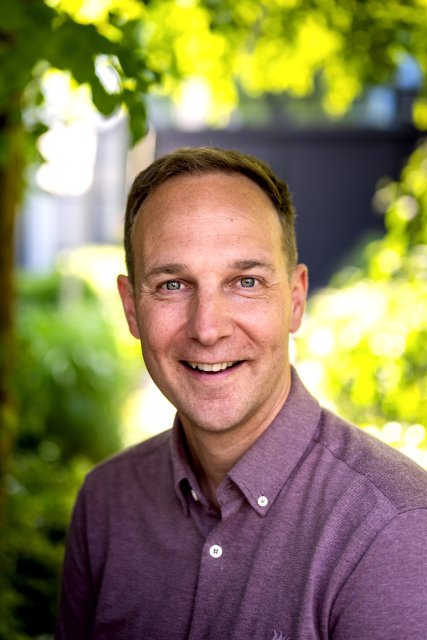 Trouwambtenaar Erwin Plantinga in paarsrood overhemd
