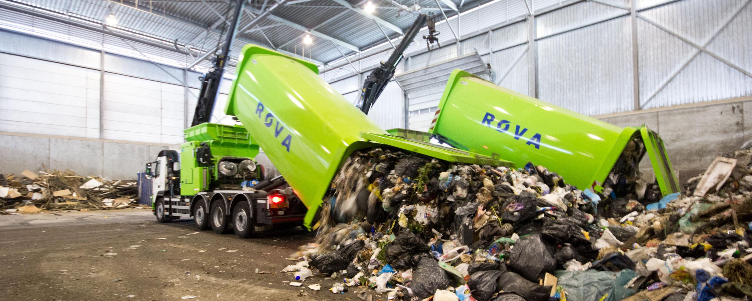 Twee groene ROVA-afvalwagens die restafval uitladen