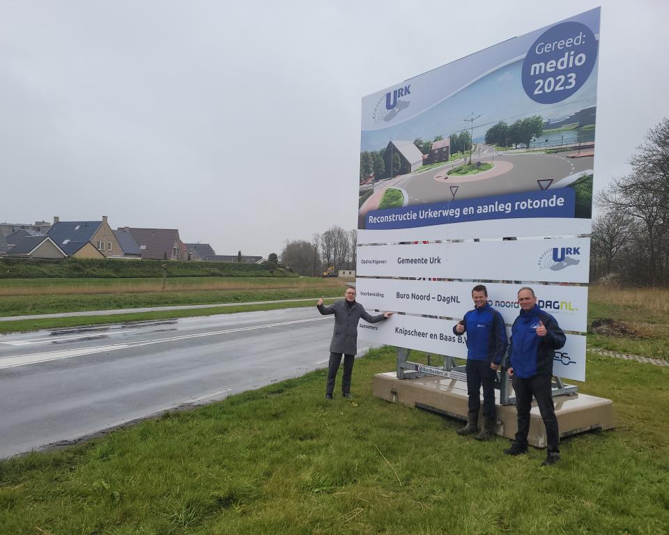 Drie mensen voor een bord met aankondiging wegwerkzaamheden Urkerweg