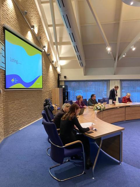 Medewerkers van de gemeente Urk zitten in de raadzaal 