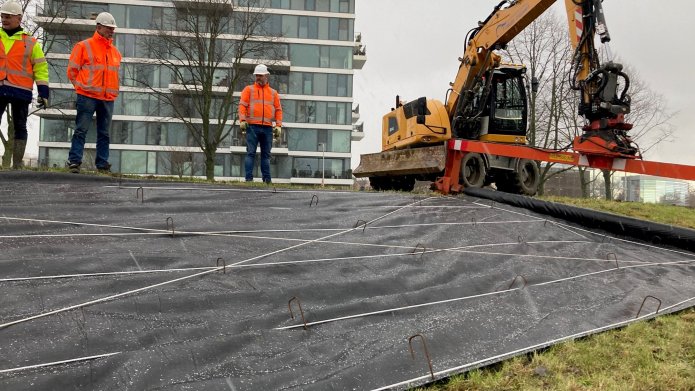 De nieuwe dijk wordt ingepakt met folie