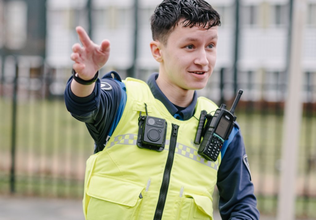Boa met donkerbruin haar en vriendelijke blik, geeft met zijn rechterhand aanwijzingen.