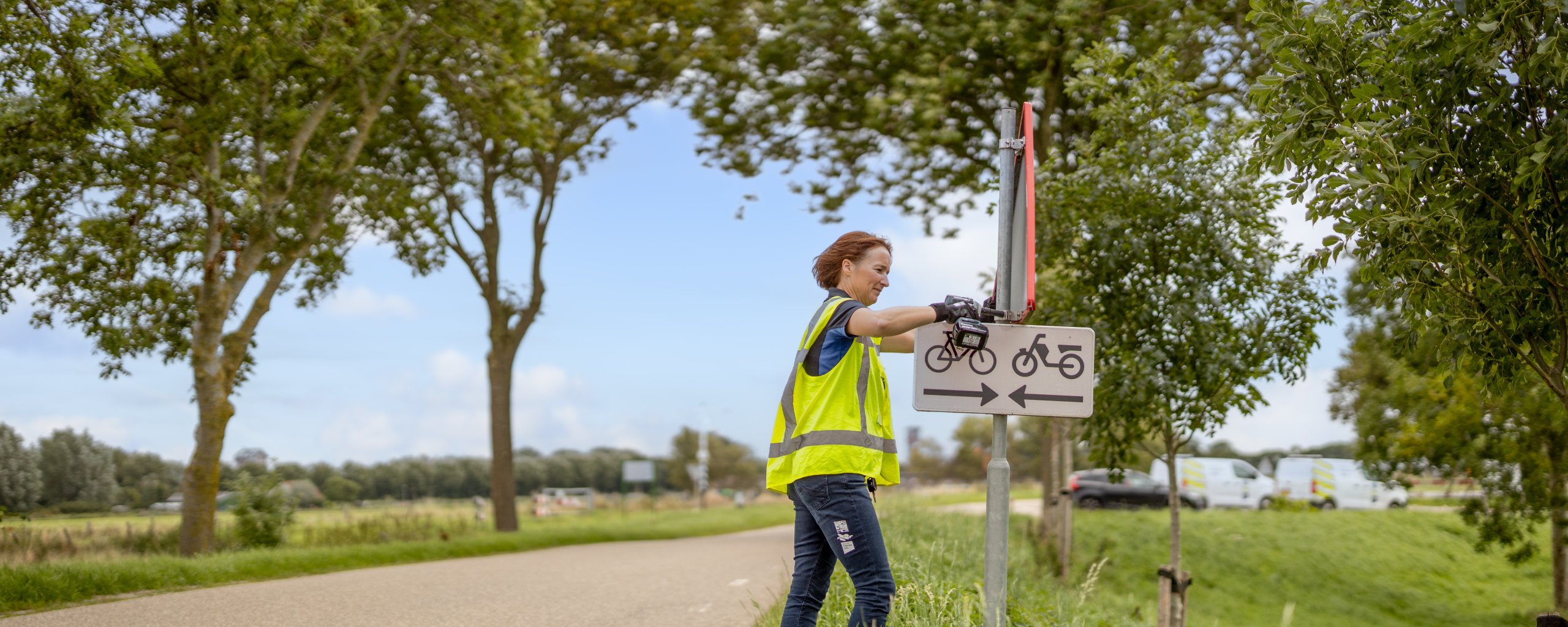 Een medewerker van waterschap Hollandse Delta staat bij een verkeersbord