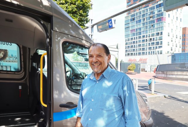 Nikolaos with a bus and shops